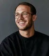Portrait of a smiling man wearing glasses, generic stock placeholder photography